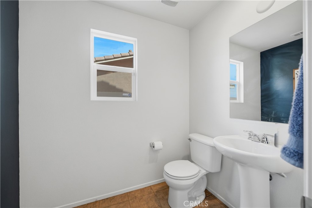 3439 Joshua Tree Court Perris, CA 92570 - Photo 28 of 49 a bathroom with a sink and a toilet