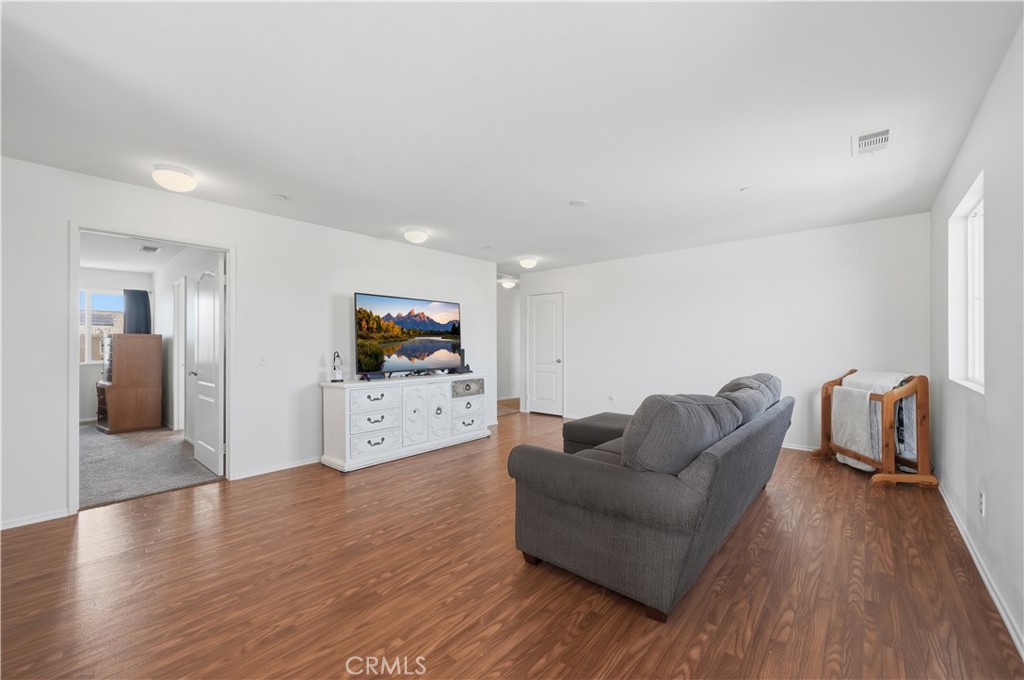3439 Joshua Tree Court Perris, CA 92570 - Photo 29 of 49 a living room with furniture and a flat screen tv