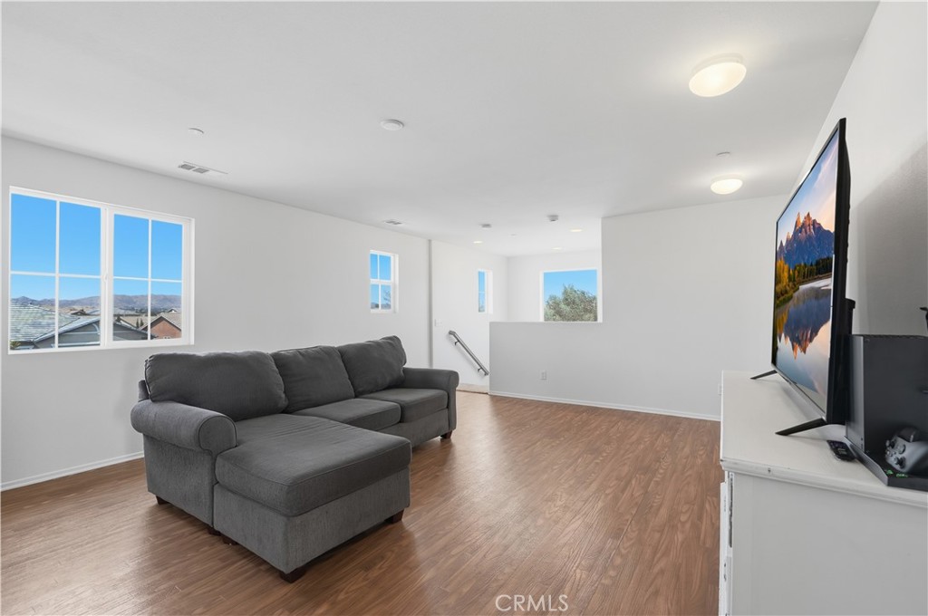 3439 Joshua Tree Court Perris, CA 92570 - Photo 31 of 49 a living room with furniture and a flat screen tv