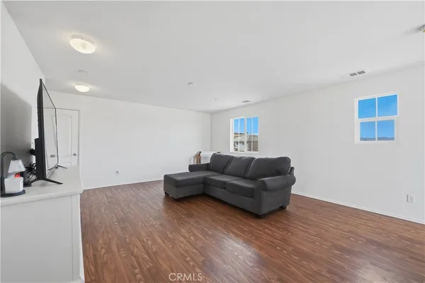 a bedroom with a bed and dresser with mirror
