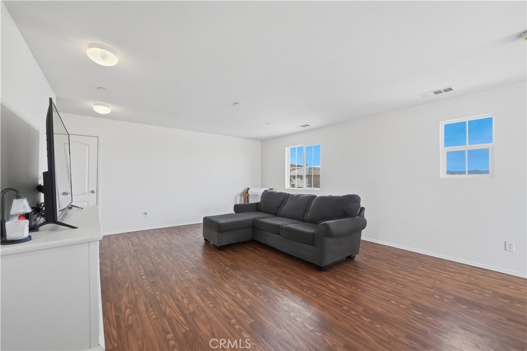 3439 Joshua Tree Court Perris, CA 92570 - Photo 32 of 49 a living room with furniture and a wooden floor