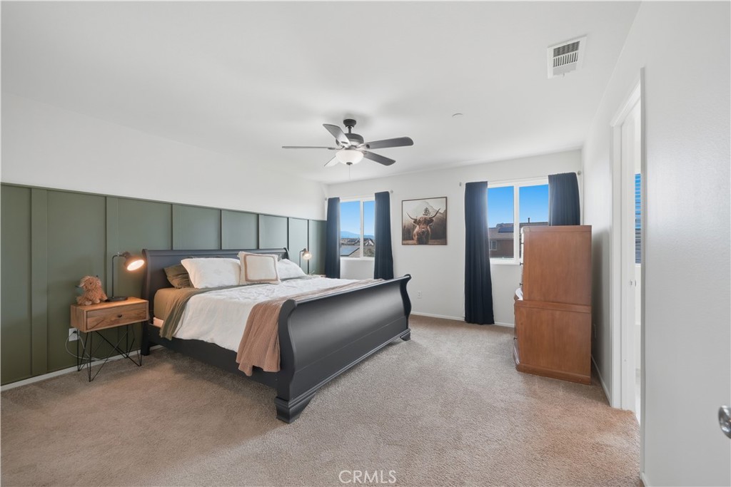 3439 Joshua Tree Court Perris, CA 92570 - Photo 33 of 49 a bed room with a bed and a ceiling fan