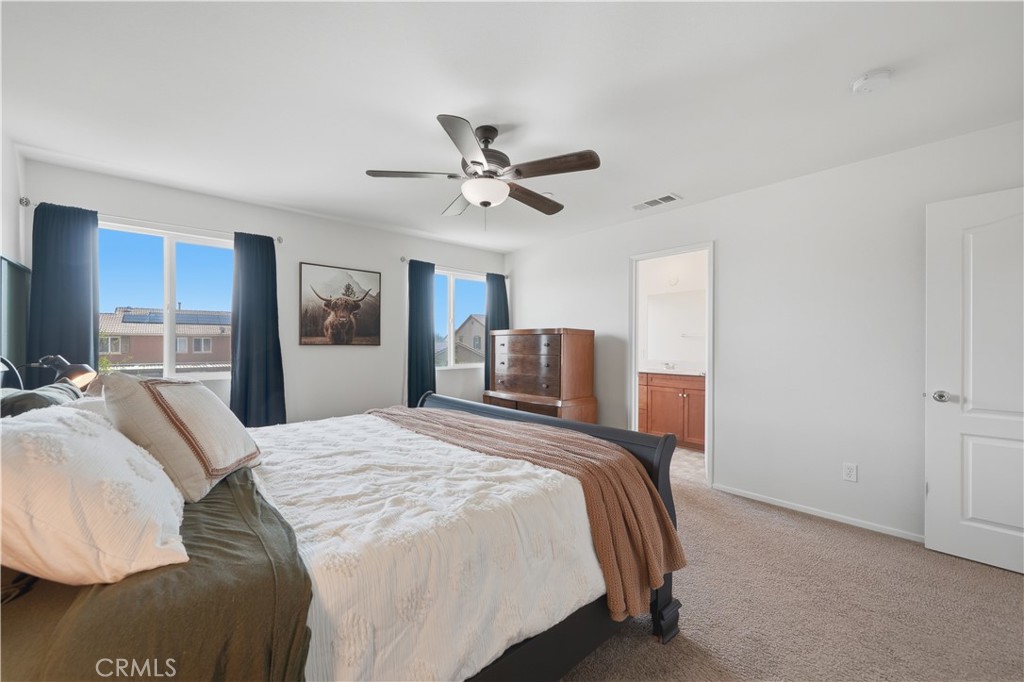 3439 Joshua Tree Court Perris, CA 92570 - Photo 34 of 49 a bedroom with a bed and dresser with mirror
