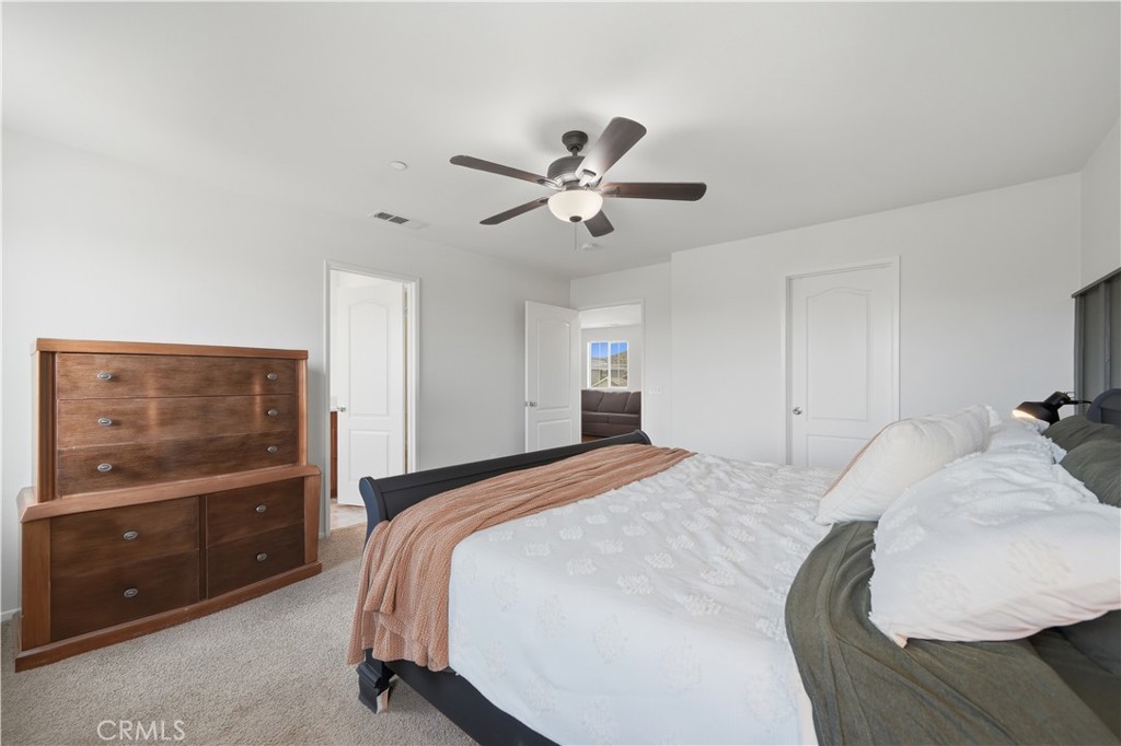 3439 Joshua Tree Court Perris, CA 92570 - Photo 35 of 49 a bedroom with a bed and a flat screen tv