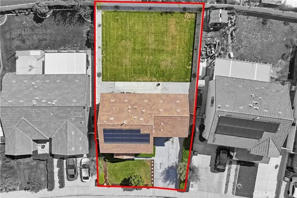 an aerial view of residential house with outdoor space and parking