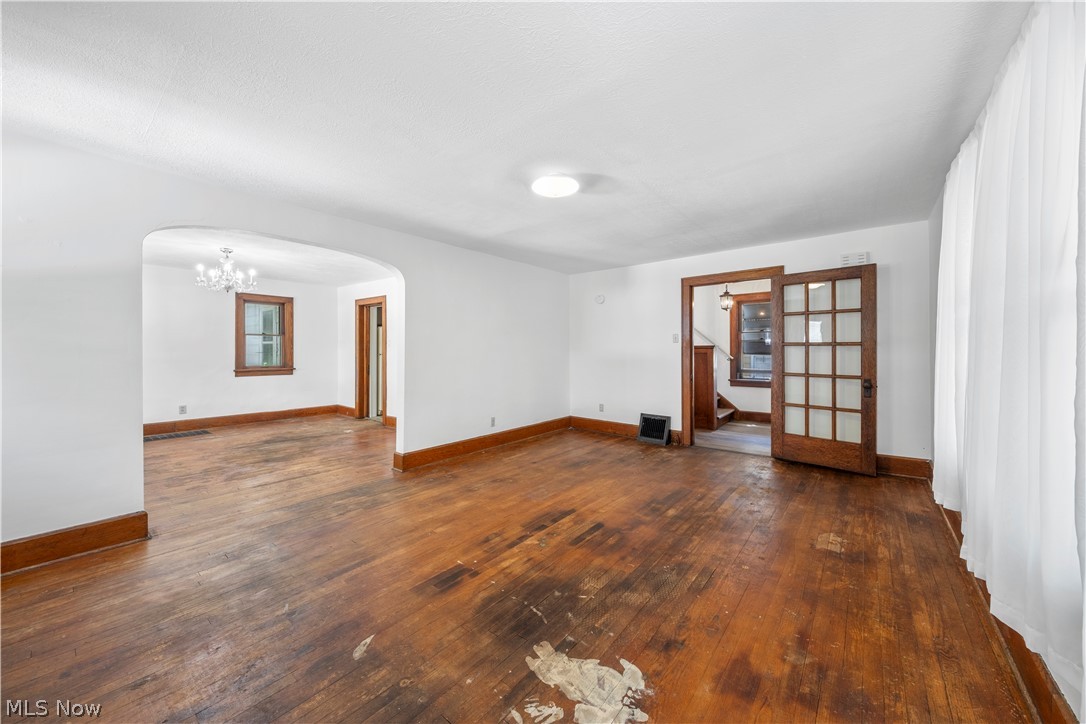 317 Ruckel Road Akron, OH 44305 - Photo 25 of 30 Unfurnished room featuring an inviting chandelier and dark wood-type flooring