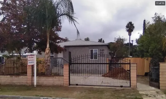 a view of a wrought iron fences in front of house