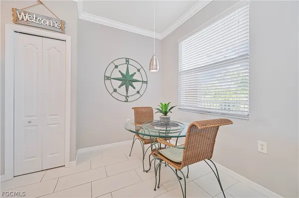 a view of a room that has a window and furniture