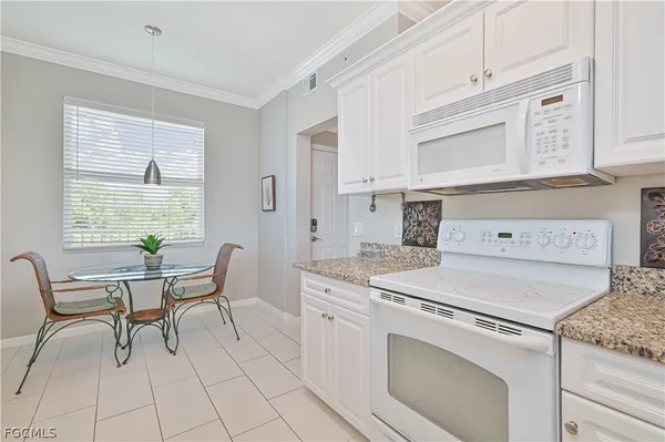 a view of kitchen with furniture and window