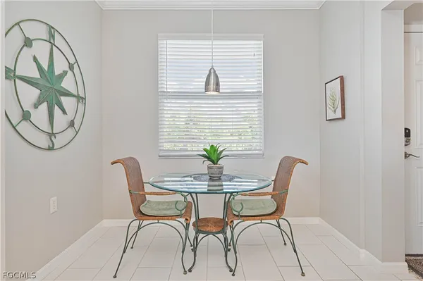 a dining room with furniture and window
