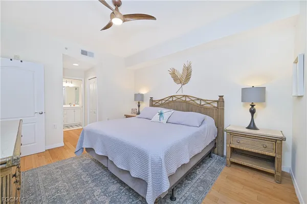 a bedroom with bed and a chandelier