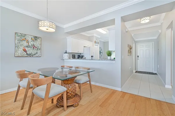 a dining room with wooden floor and a chandelier