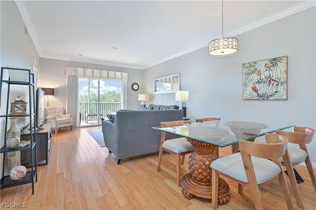 a view of a dining room with furniture a chandelier and wooden floor