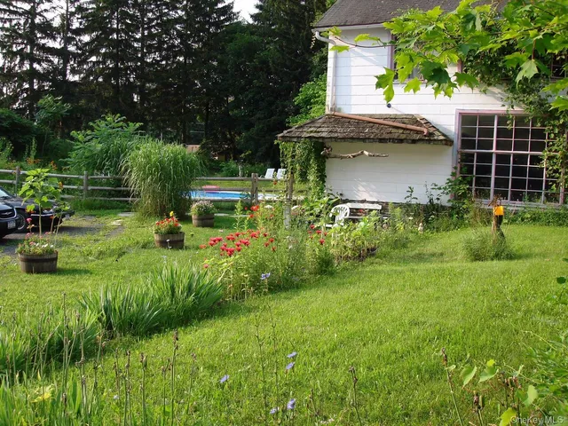 a view of backyard of house with green space