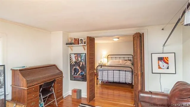 a bedroom with a bed and a television