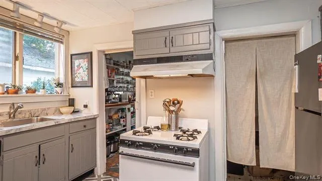 a kitchen with cabinets and window