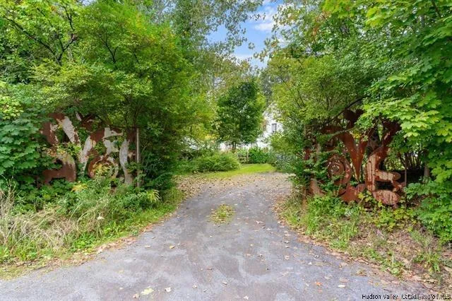 a view of a pathway with a tree