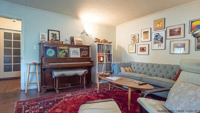 a living room with furniture a piano and a fireplace