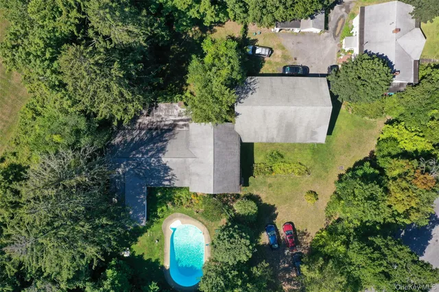 an aerial view of a house with a yard and a fountain
