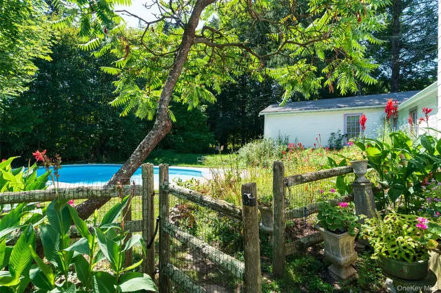a backyard of a house with lots of green space and garden