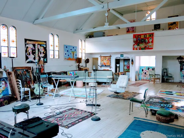 a living room with lots of furniture and kitchen view