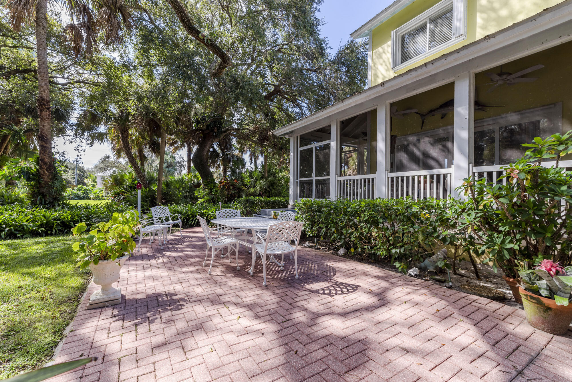 2267 Windsor Road Palm Beach Gardens, FL 33410 - Photo 12 of 45 a view of a chair and table in backyard of the house