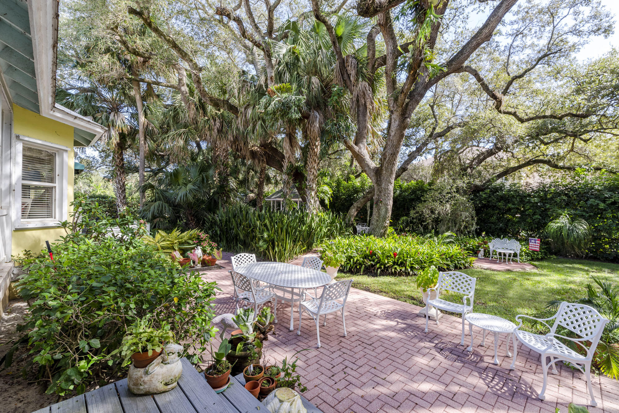 2267 Windsor Road Palm Beach Gardens, FL 33410 - Photo 13 of 45 a view of a chair and table in the garden