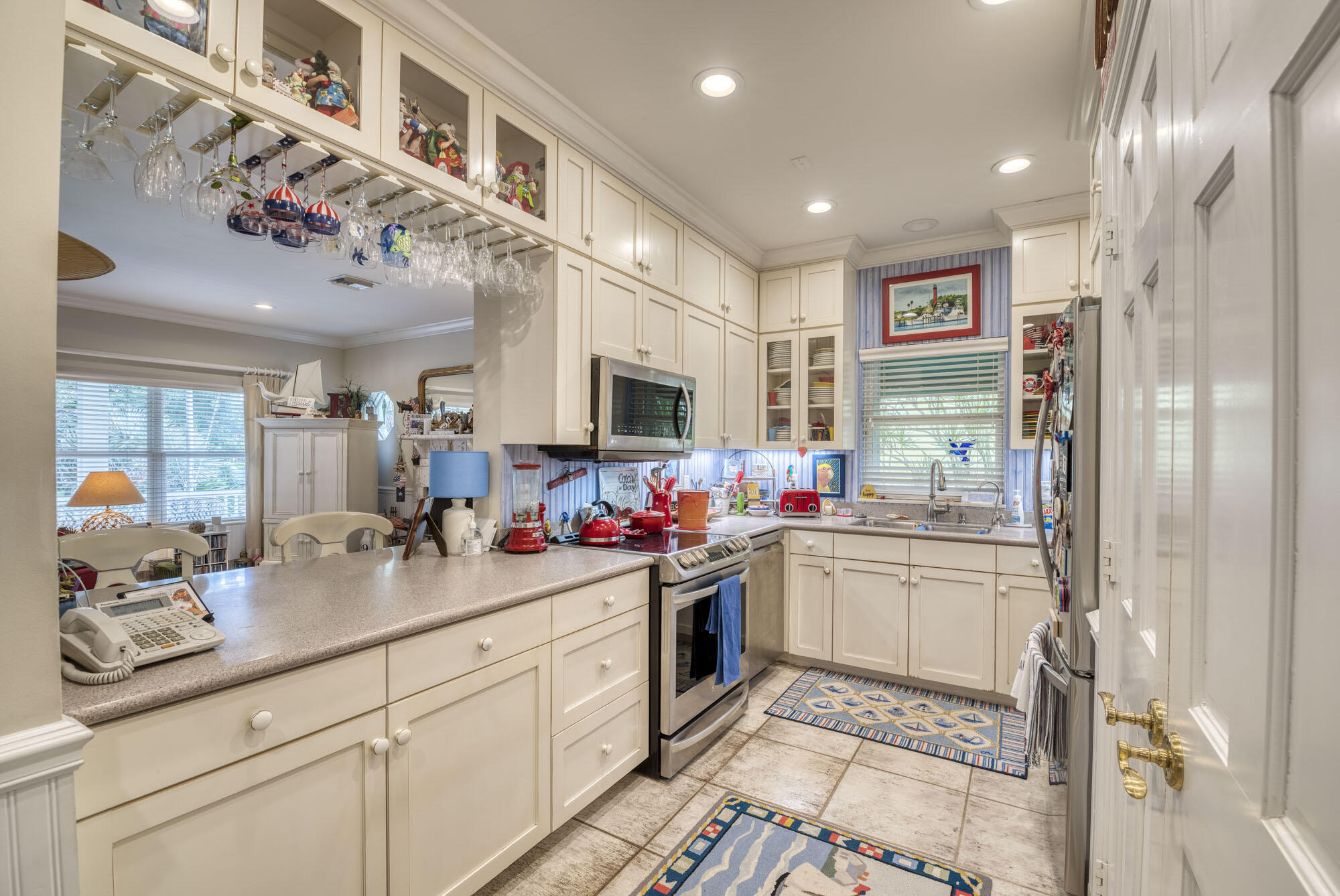 2267 Windsor Road Palm Beach Gardens, FL 33410 - Photo 20 of 45 a kitchen with a sink cabinets and stainless steel appliances