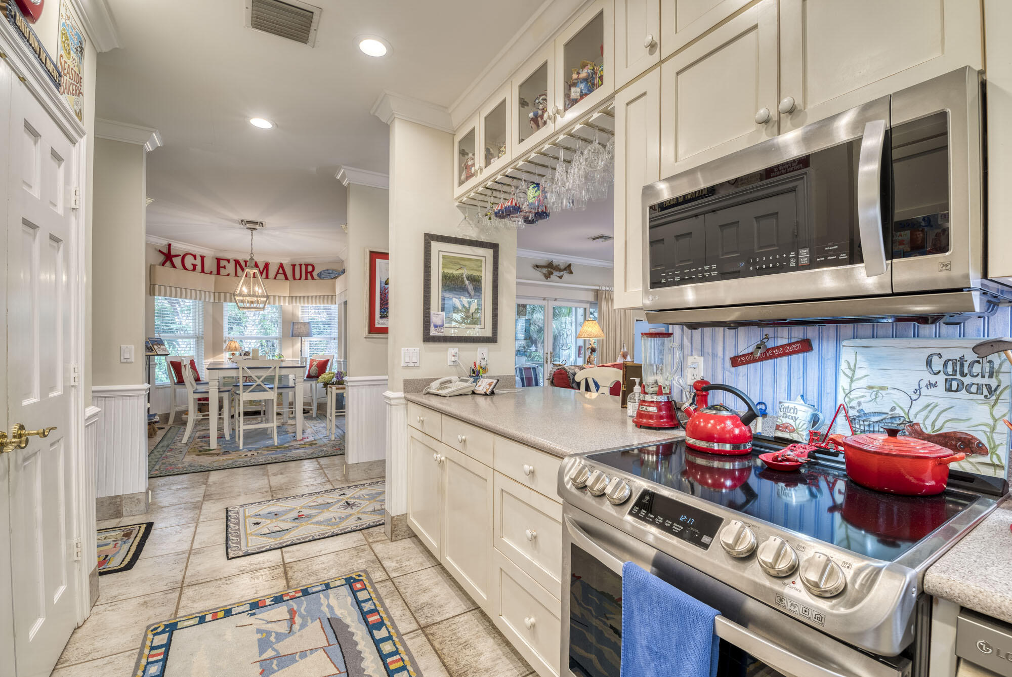 2267 Windsor Road Palm Beach Gardens, FL 33410 - Photo 22 of 45 a kitchen with stainless steel appliances granite countertop a stove and cabinets