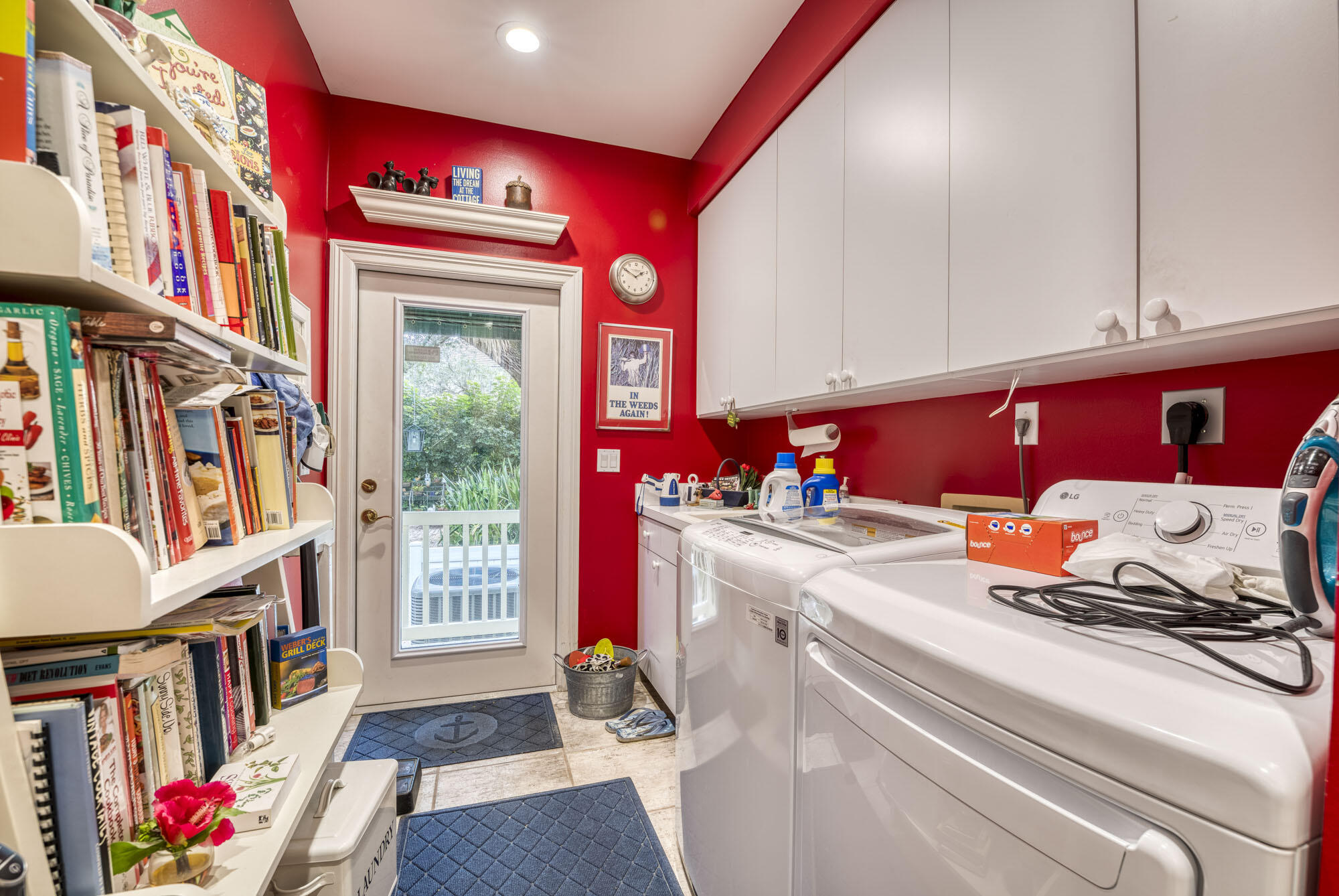 2267 Windsor Road Palm Beach Gardens, FL 33410 - Photo 26 of 45 a utility room with dryer washer and a book shelf