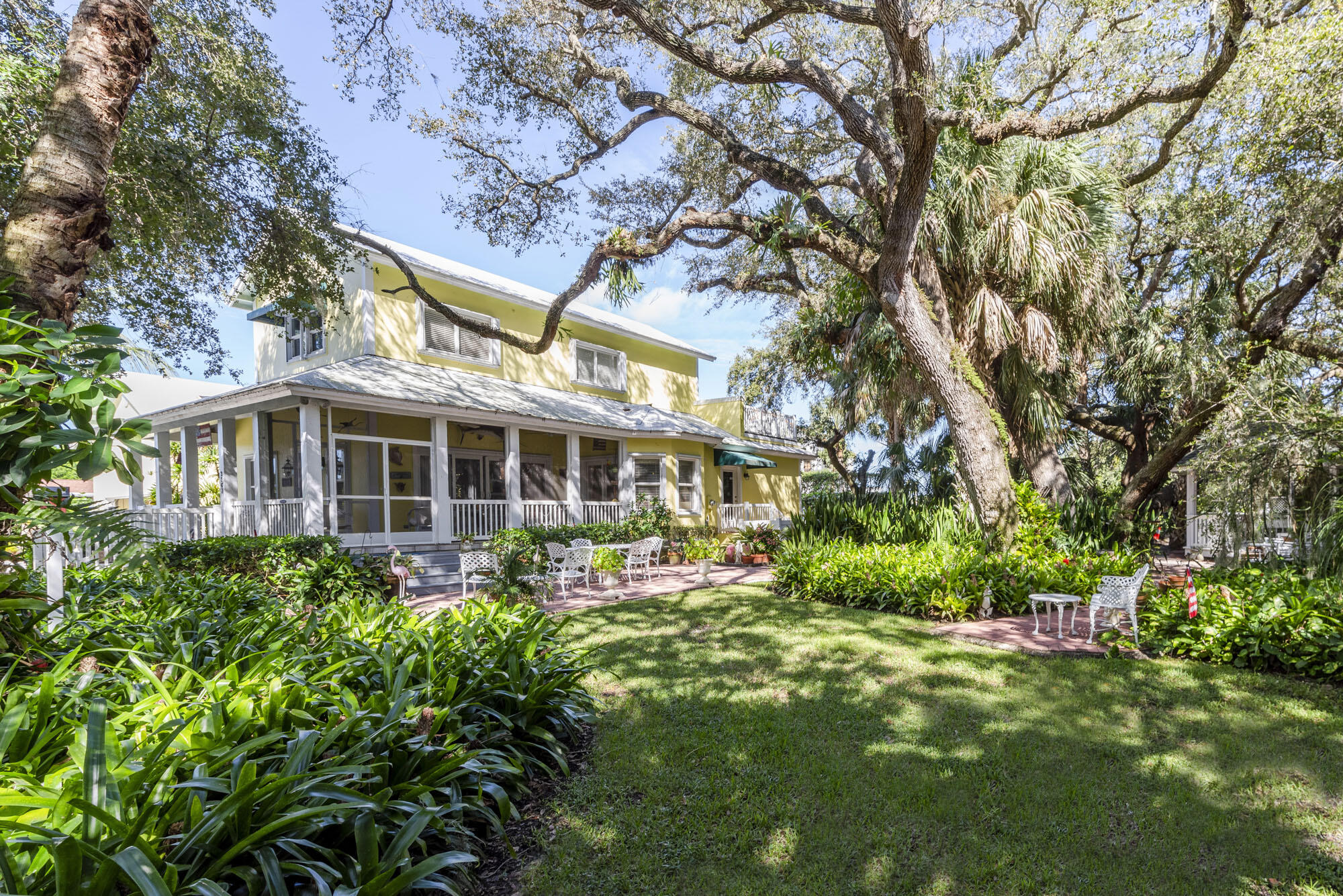 2267 Windsor Road Palm Beach Gardens, FL 33410 - Photo 9 of 45 a front view of a house with a yard and potted plants