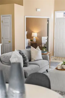 a living room with furniture and a lamp