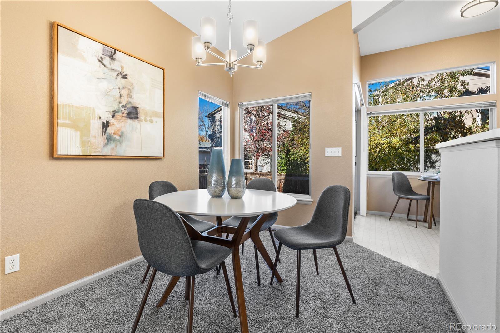 12799 East Wyoming Circle Aurora, CO 80012 - Photo 15 of 44 a view of a dining room with furniture window and outside view