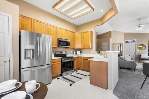 a kitchen with cabinets and stainless steel appliances