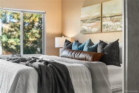 a bedroom with bed and a window