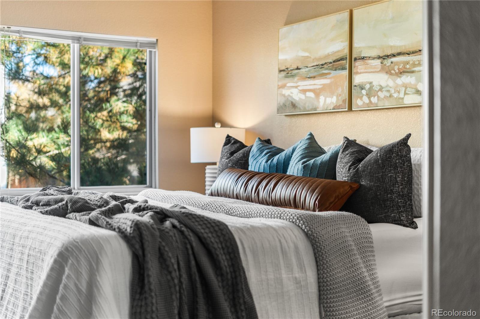 12799 East Wyoming Circle Aurora, CO 80012 - Photo 22 of 44 a bedroom with bed and a window
