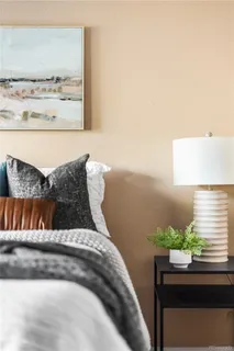 a bedroom with a bed and a potted plant