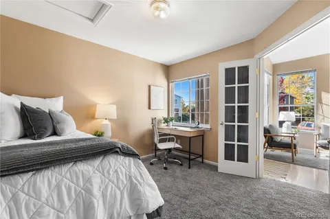 a bedroom with a bed and a desk