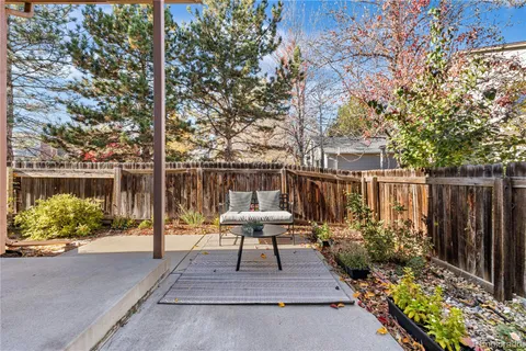 a view of backyard with seating space and trees