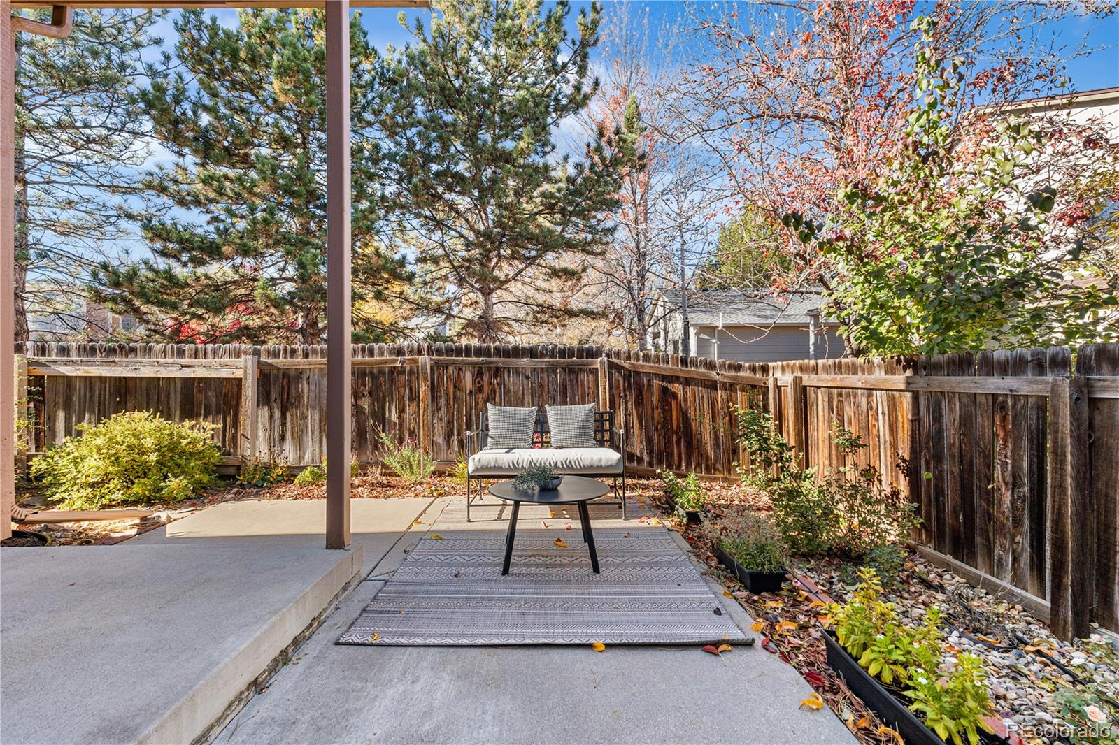 12799 East Wyoming Circle Aurora, CO 80012 - Photo 36 of 44 a view of backyard with seating space and trees