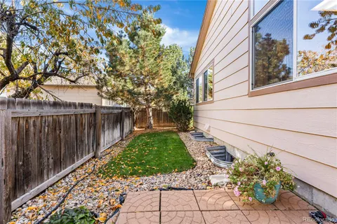 a pathway of a house with wooden fence