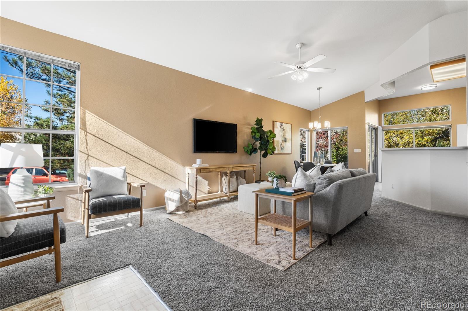 12799 East Wyoming Circle Aurora, CO 80012 - Photo 4 of 44 a living room with furniture and a flat screen tv