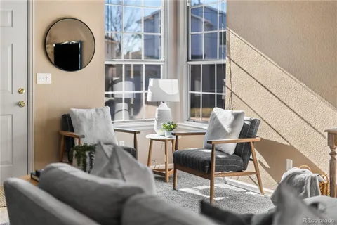 a living room with furniture and a mirror