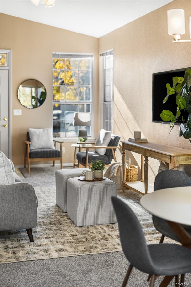 12799 East Wyoming Circle Aurora, CO 80012 - Photo 10 of 44 a living room with furniture and a large window