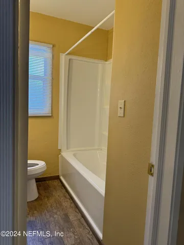 a bathroom with a toilet and a shower