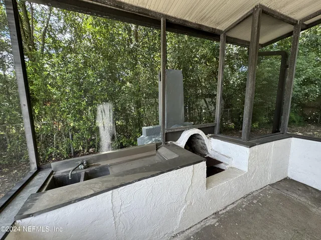 a view of a sink and table in the balcony