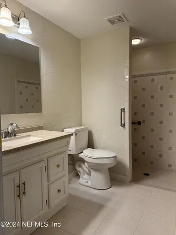 a bathroom with a toilet sink and a mirror