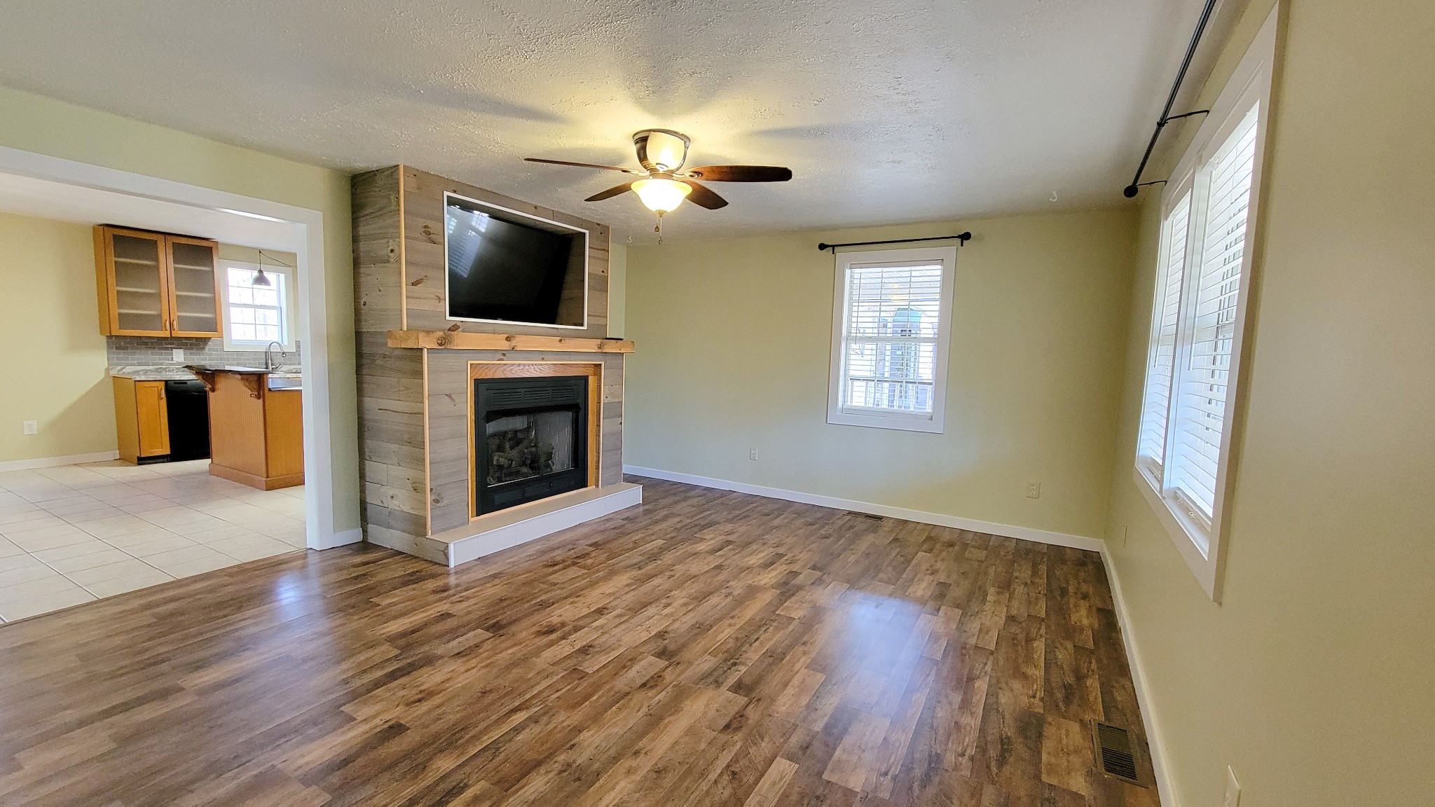 1678 4 Seasons Road Smithville, TN 37166 - Photo 24 of 43 a view of a livingroom with a flat screen tv ceiling fan and window