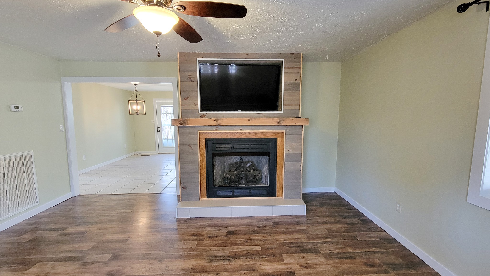 1678 4 Seasons Road Smithville, TN 37166 - Photo 25 of 43 a living room with a fireplace and a flat screen tv