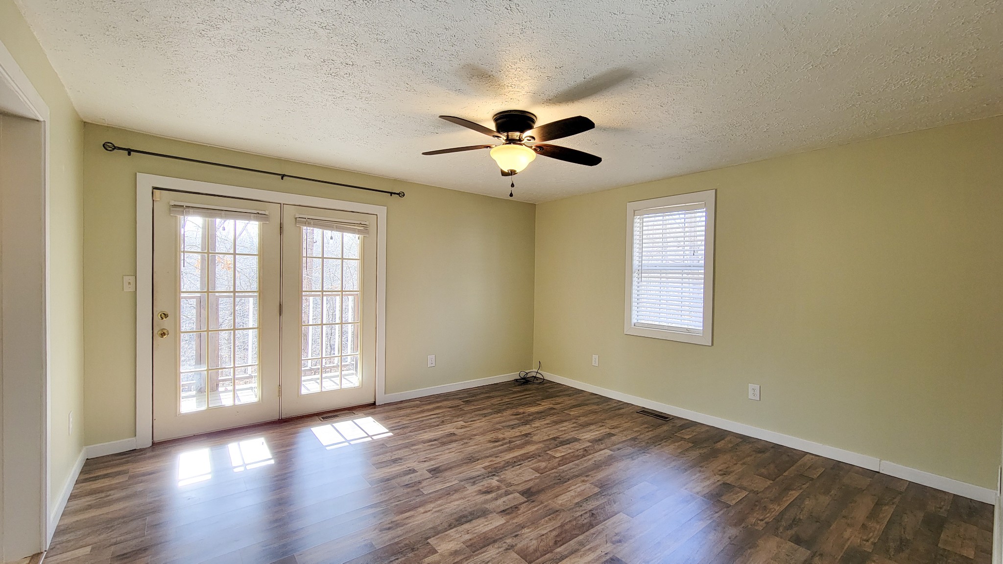 1678 4 Seasons Road Smithville, TN 37166 - Photo 31 of 43 a view of an empty room with a window and wooden floor